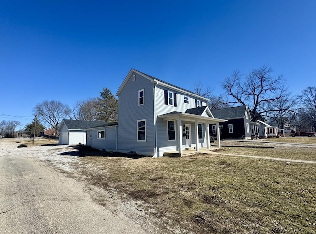 view of front of house featuring a garage, a porch, and driveway