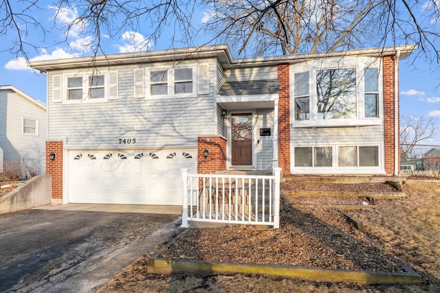 view of front of property with a garage, aphalt driveway, and brick siding