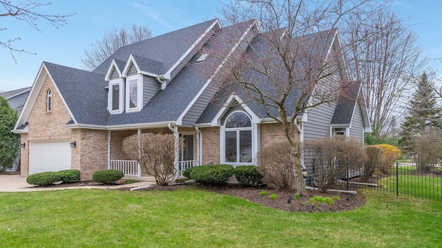 view of front of home with covered porch, brick siding, fence, and a front yard