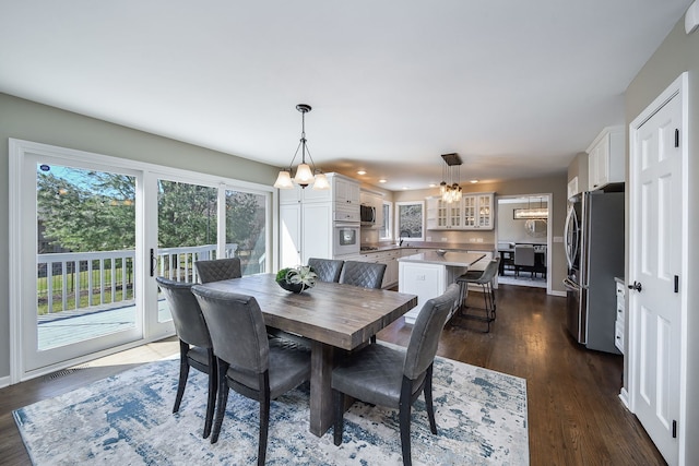 dining space featuring visible vents, recessed lighting, a chandelier, and dark wood-style floors