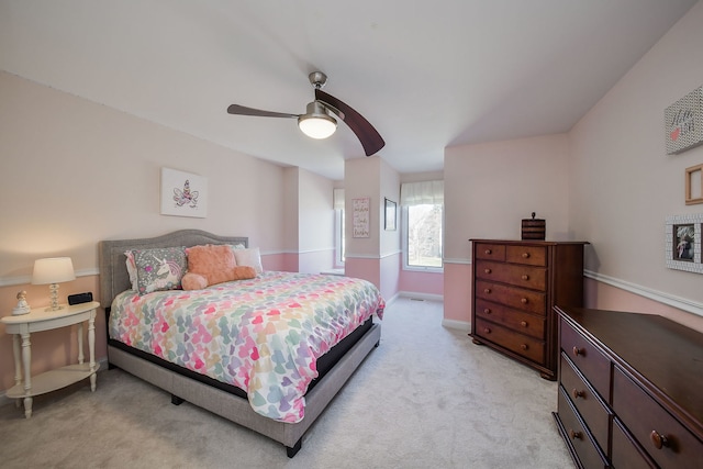 bedroom with ceiling fan, light colored carpet, and baseboards