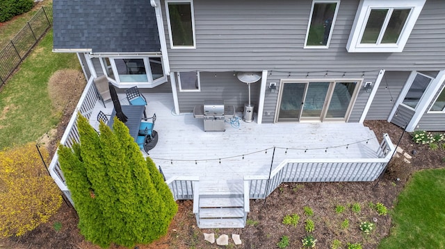 wooden terrace featuring a fenced backyard and grilling area
