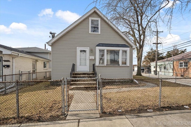 view of front of house with entry steps, a fenced front yard, and a gate