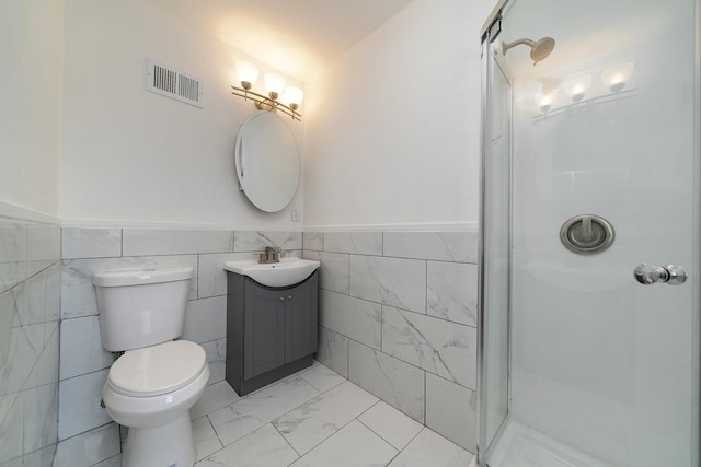 full bathroom with visible vents, toilet, marble finish floor, a shower stall, and vanity