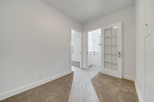 interior space featuring carpet flooring, baseboards, and ornamental molding