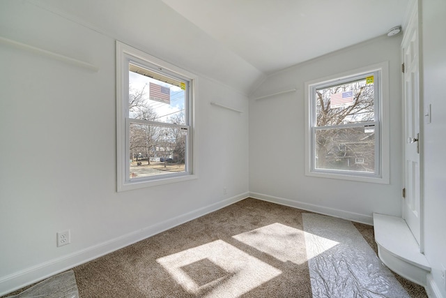 additional living space with vaulted ceiling, carpet flooring, and baseboards