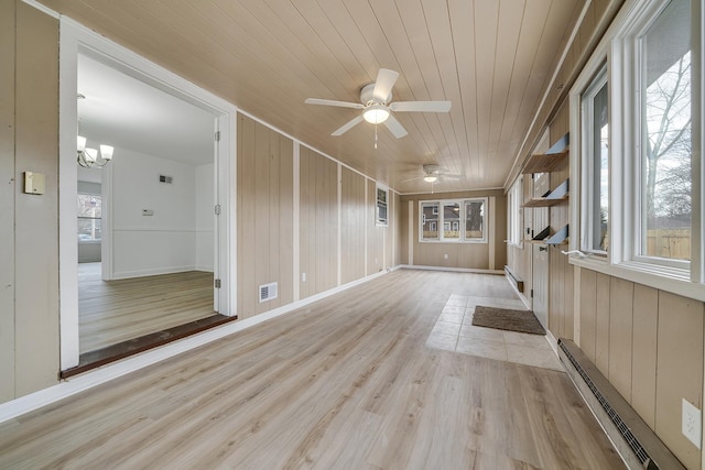 interior space with plenty of natural light, wood ceiling, visible vents, and baseboard heating