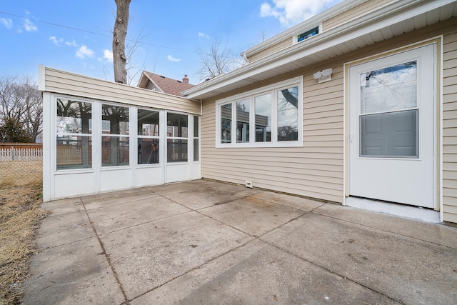 back of house with a patio area, a sunroom, and fence