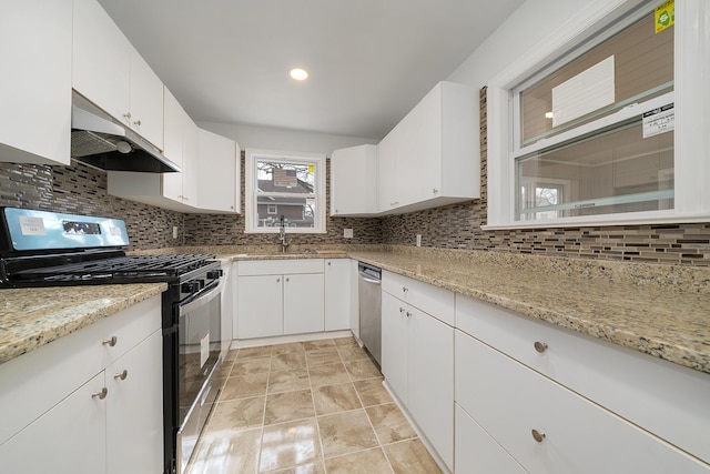 kitchen with backsplash, under cabinet range hood, white cabinets, stainless steel appliances, and a sink