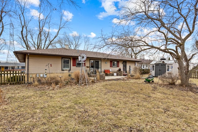 rear view of house with a patio, a chimney, a storage shed, fence, and an outdoor structure