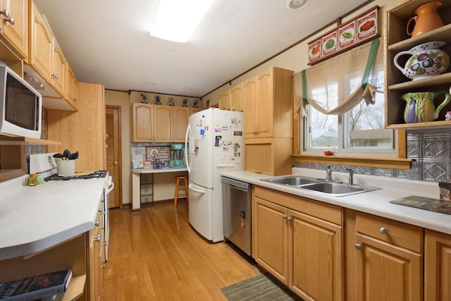 kitchen with white appliances, light countertops, a sink, and open shelves