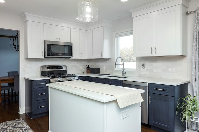 kitchen with a sink, stainless steel appliances, light countertops, and white cabinetry