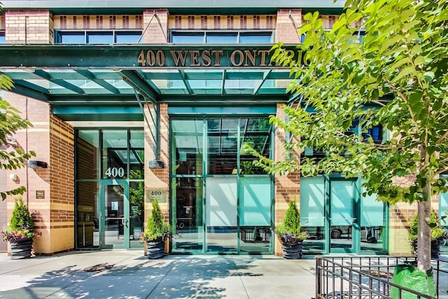 property entrance featuring brick siding