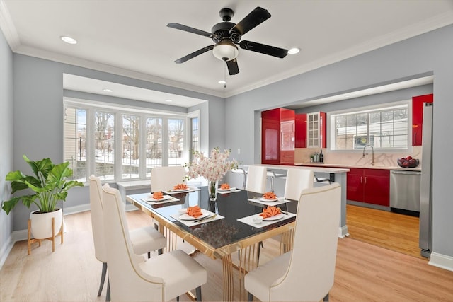 dining area with ornamental molding, light wood-type flooring, baseboards, and recessed lighting