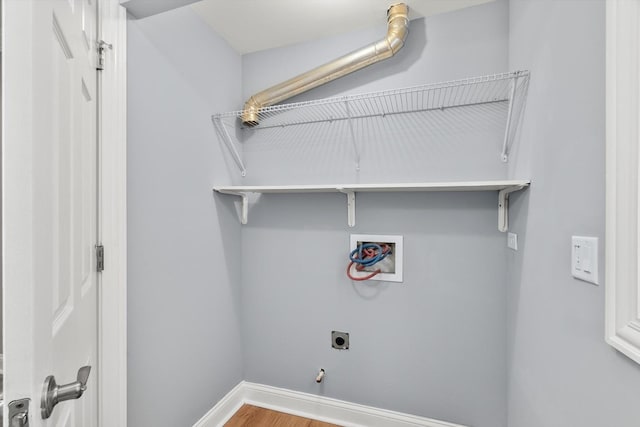 laundry room featuring laundry area, baseboards, wood finished floors, washer hookup, and electric dryer hookup