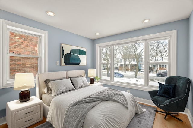 bedroom featuring recessed lighting, wood finished floors, and baseboards