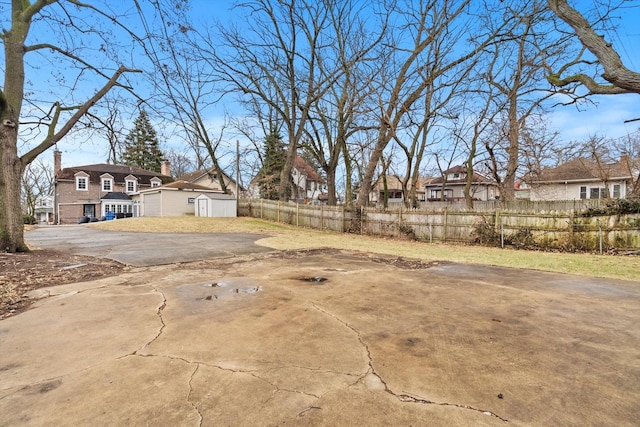 view of yard featuring a residential view and fence