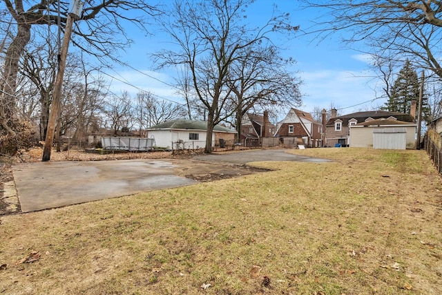 view of yard with a storage unit, fence, and an outdoor structure