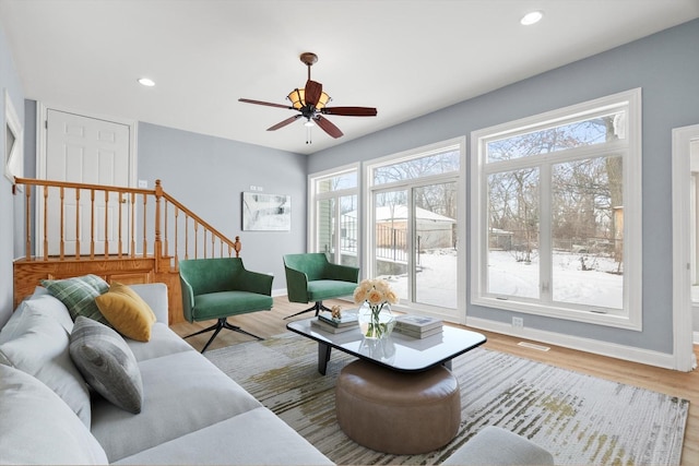 living area featuring stairway, recessed lighting, wood finished floors, and baseboards