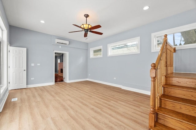 interior space with light wood finished floors, multiple windows, and baseboards