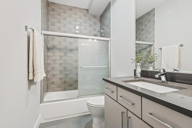 full bathroom featuring vanity, toilet, and bath / shower combo with glass door