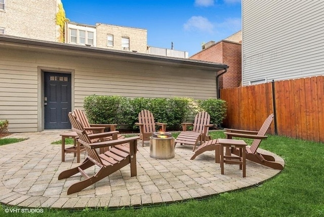 view of patio / terrace featuring an outdoor fire pit and fence