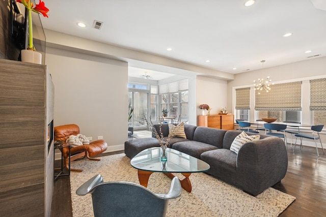 living area featuring recessed lighting, wood finished floors, visible vents, and an inviting chandelier