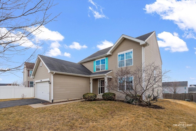 traditional-style home featuring aphalt driveway, a front lawn, and fence