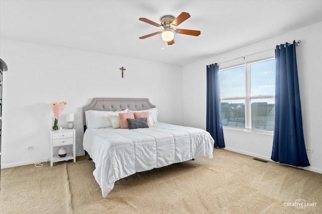 bedroom featuring carpet floors, visible vents, ceiling fan, and baseboards