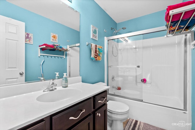 full bath featuring combined bath / shower with glass door, vanity, and toilet