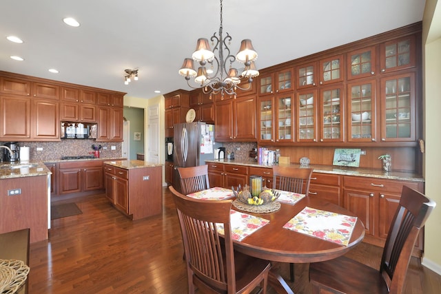 dining room featuring a notable chandelier, recessed lighting, and dark wood-style flooring