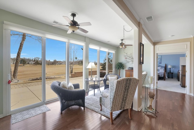 sunroom / solarium featuring visible vents and a ceiling fan