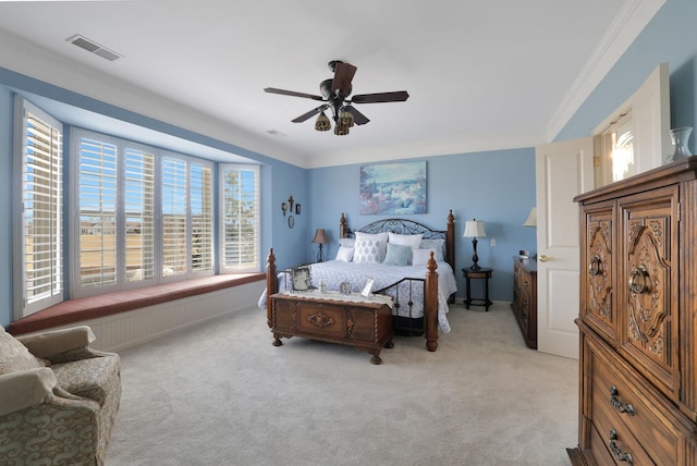 bedroom with ceiling fan, visible vents, light colored carpet, and ornamental molding