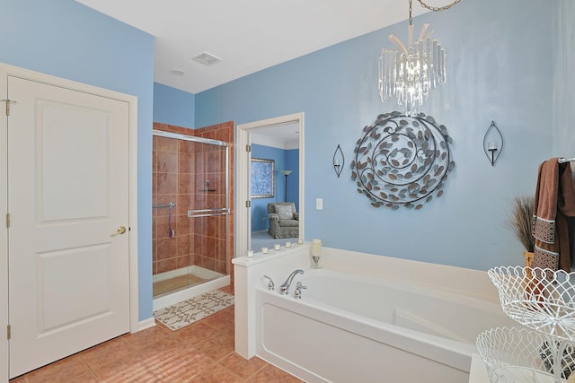 full bath featuring tile patterned floors, visible vents, a stall shower, an inviting chandelier, and a bath