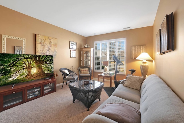 carpeted living room featuring visible vents and baseboards