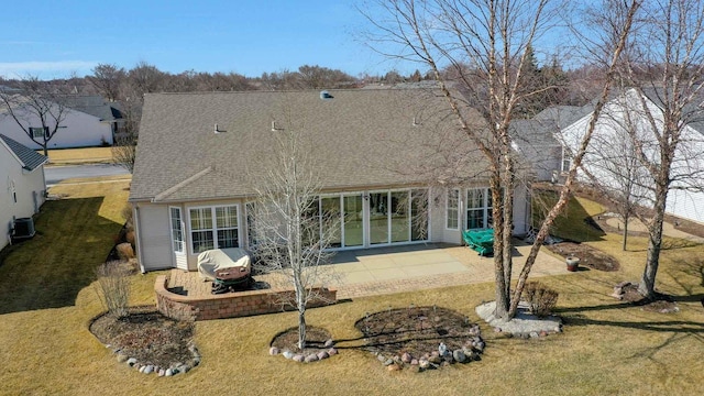 rear view of house featuring a yard, a patio, roof with shingles, and cooling unit