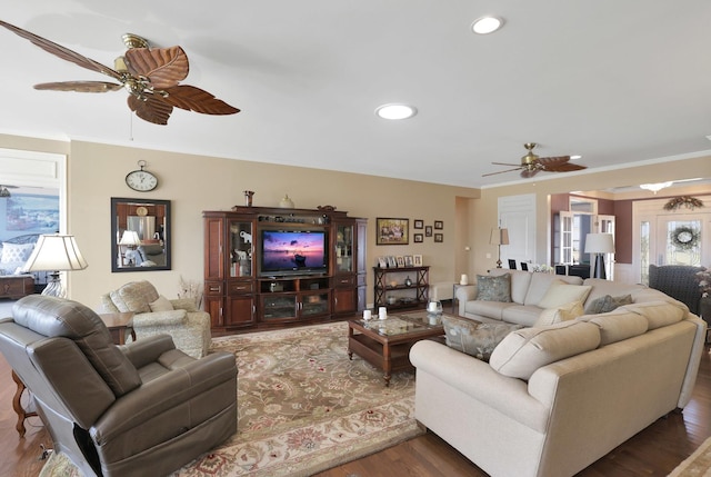 living area with recessed lighting, wood finished floors, a ceiling fan, and crown molding