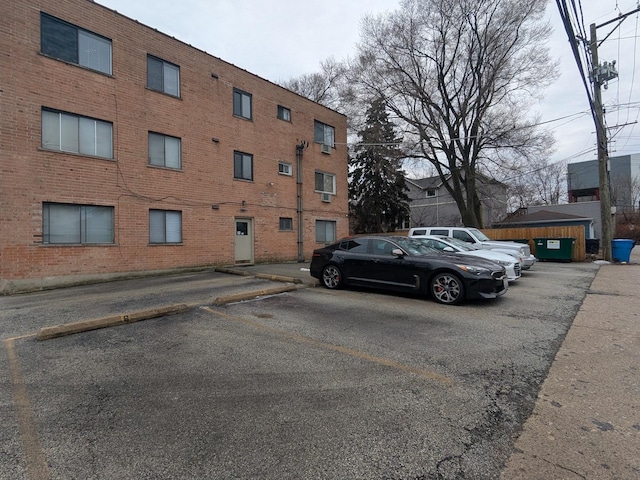 view of building exterior with uncovered parking