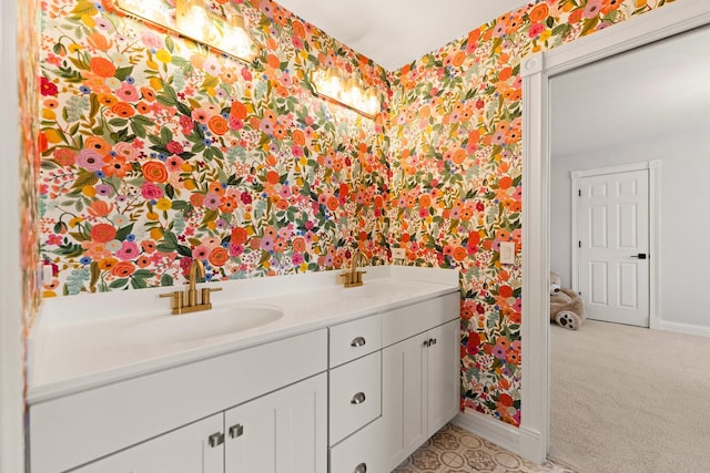 bathroom with baseboards, a sink, and wallpapered walls