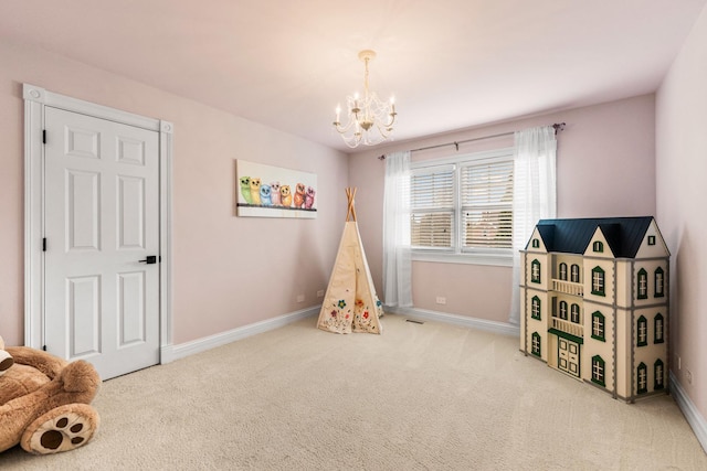 rec room with baseboards, carpet, and a notable chandelier