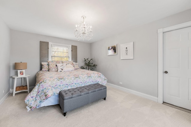 bedroom featuring an inviting chandelier, baseboards, and carpet floors