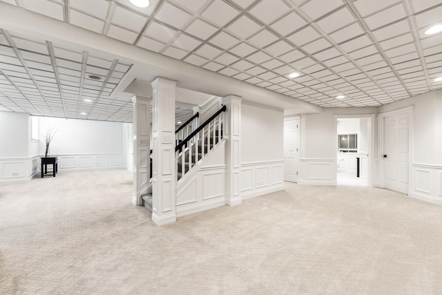 basement featuring recessed lighting, a decorative wall, and light carpet