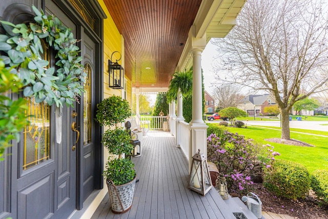 deck featuring covered porch and a residential view