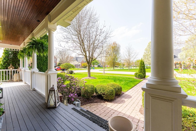 wooden deck featuring a yard and a porch