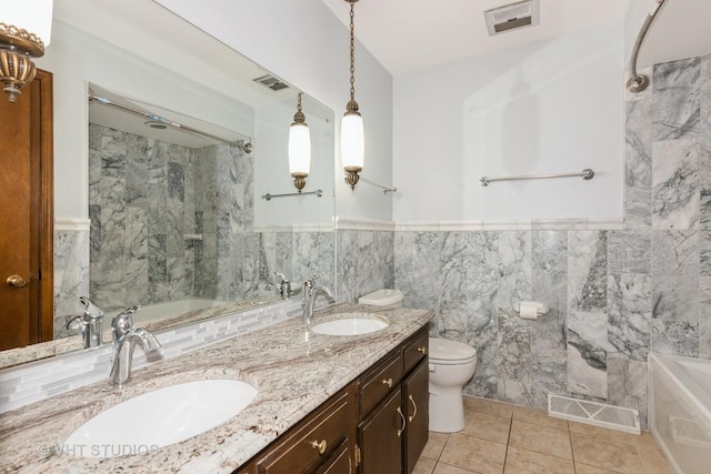 bathroom featuring double vanity, visible vents, and a sink