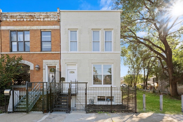 view of property featuring a fenced front yard and brick siding