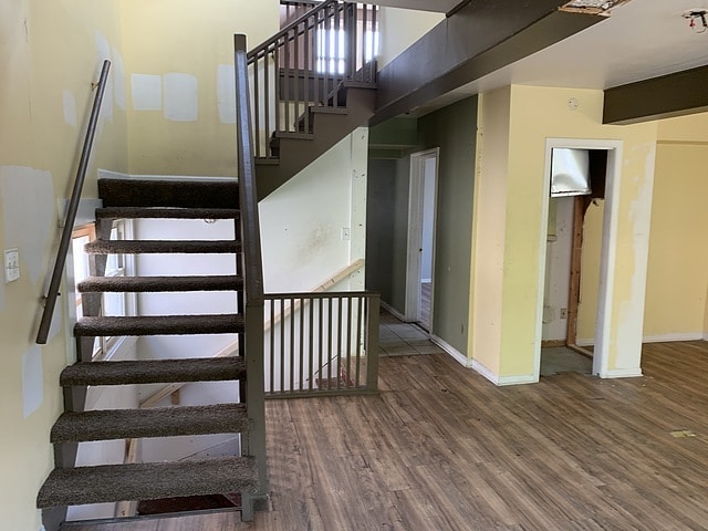 stairs featuring baseboards and wood finished floors