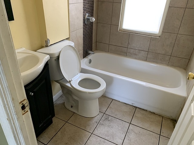 full bathroom with vanity, tile patterned flooring, and toilet