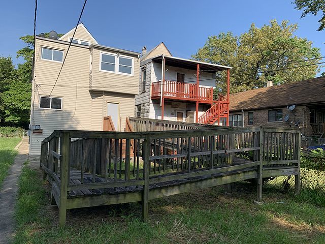 rear view of house with a wooden deck