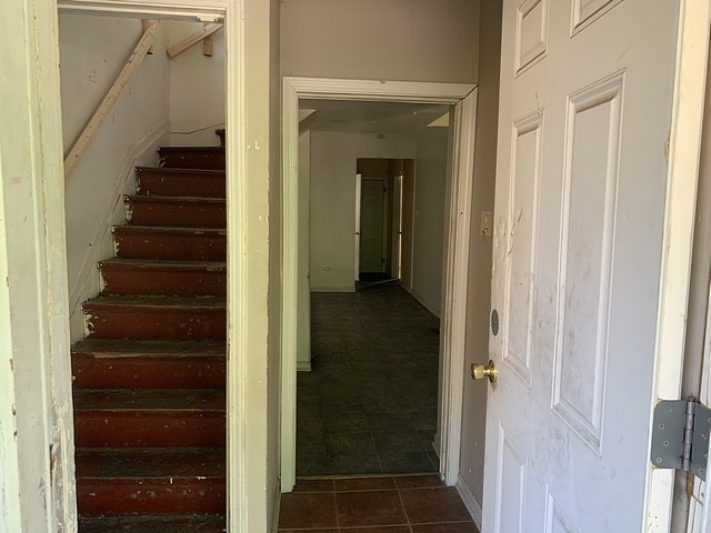 stairs featuring tile patterned flooring